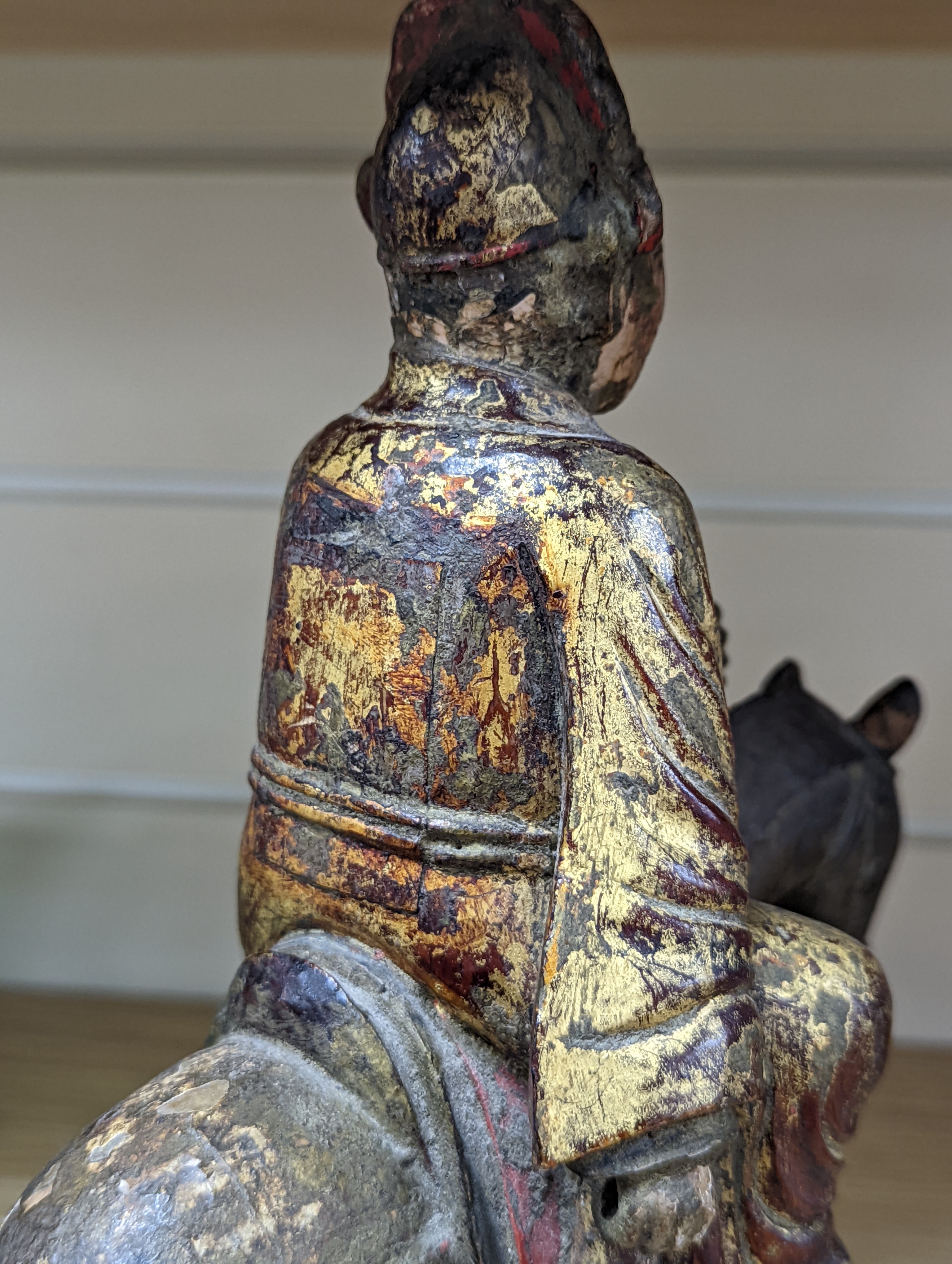 An 18th/19th century Chinese lacquered wood group of an official riding a horse, 30cm